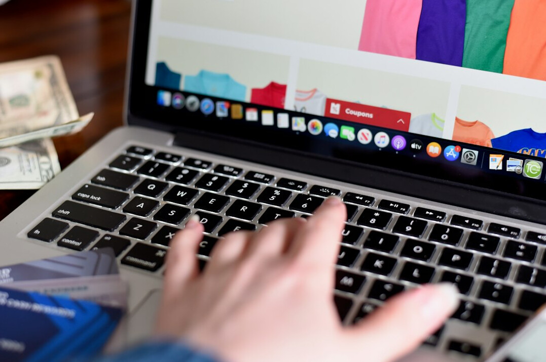 person calculating expenses on laptop